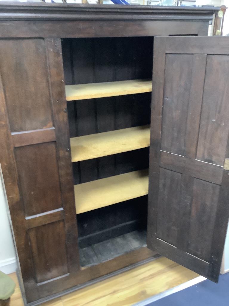 An 18th century and later panelled oak cabinet, width 130cm, depth 40cm, height 173cm